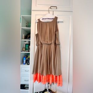 Beige and cumkwat pleated dress with patent leather belt.